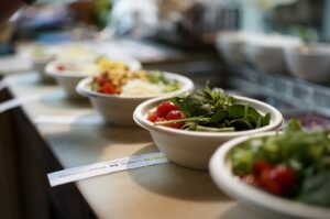 Different types of salads displayed in bowls at a Singapore Hawker Centre, highlighting vibrant colors and textures.