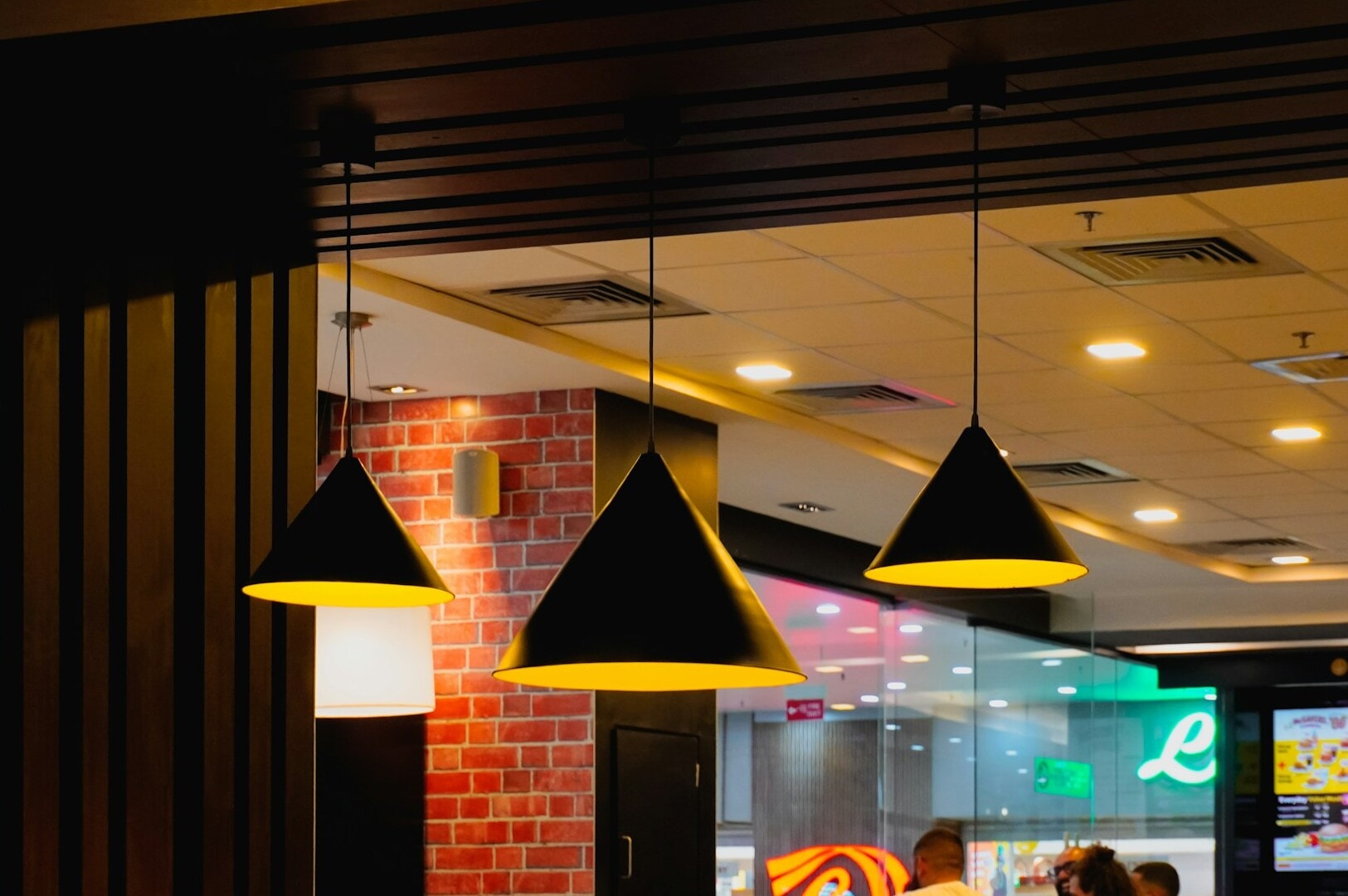 Interior of a Singapore Hawker Centre showcasing a vast dining space with multiple decorative lamps.