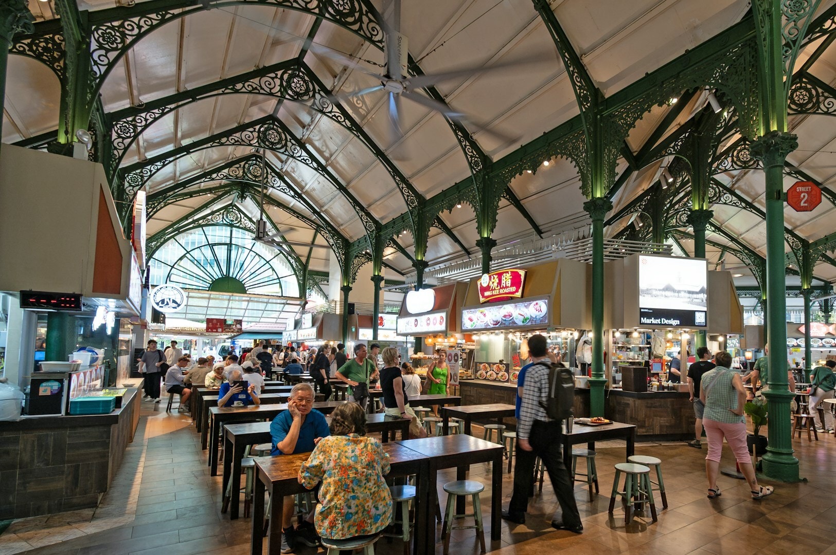 Vibrant food court scene at Maxwell Hawker Centre, showcasing diverse food options and communal seating in Newtown Market.