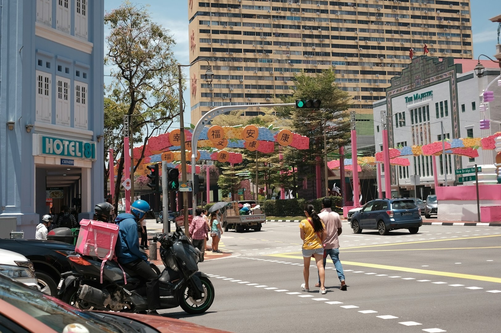 Street view of Maxwell Hawker Centre, showcasing cars and people navigating the bustling area.