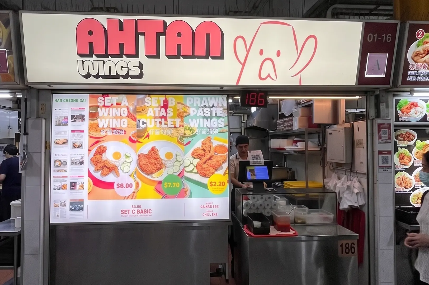 Ah Tan Wings fried chicken hawker stall with a menu board displaying prawn paste wings.