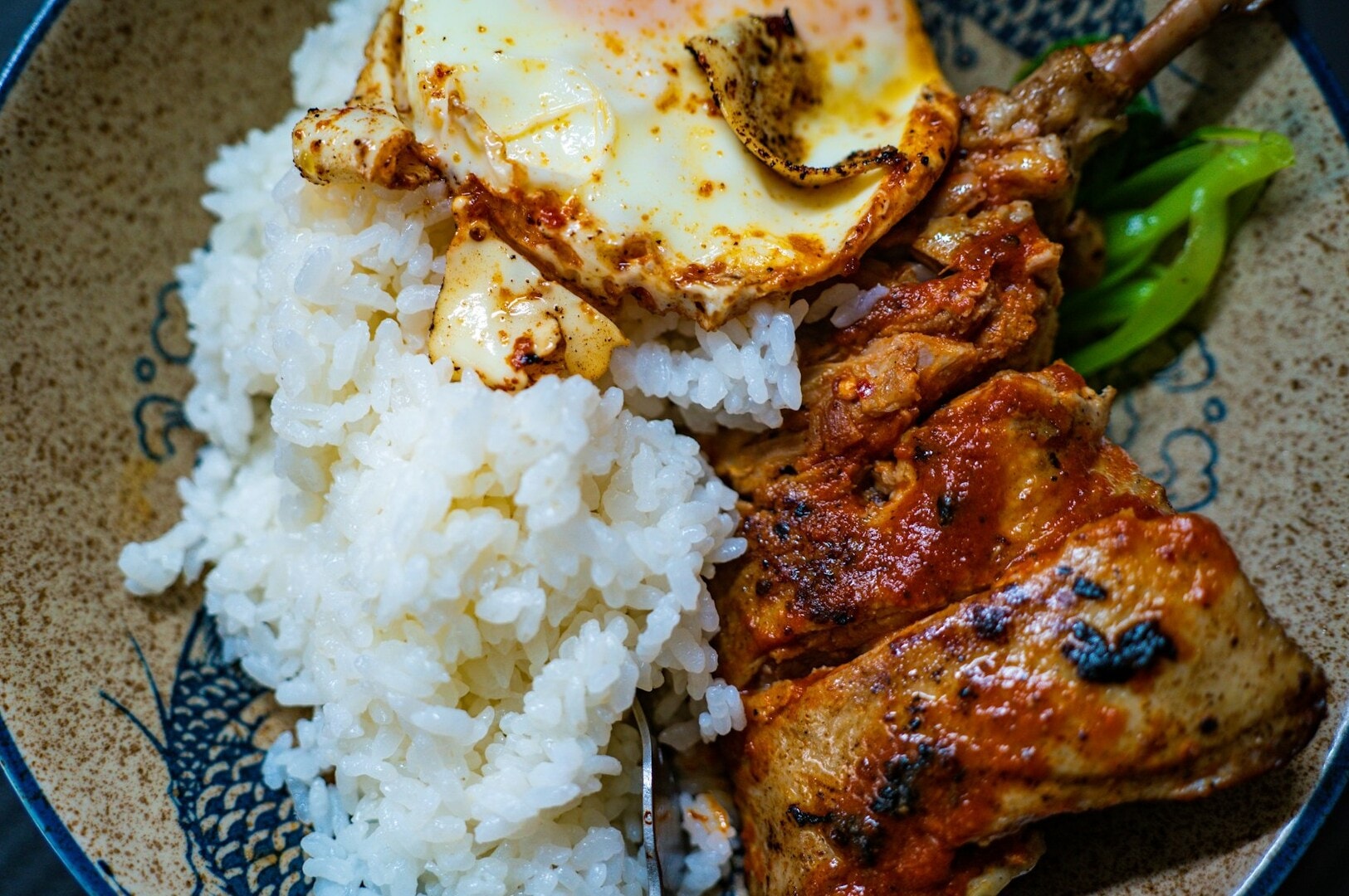  A serving of rice accompanied by a fried egg, featured in a Tiong Bahru lunch setting.