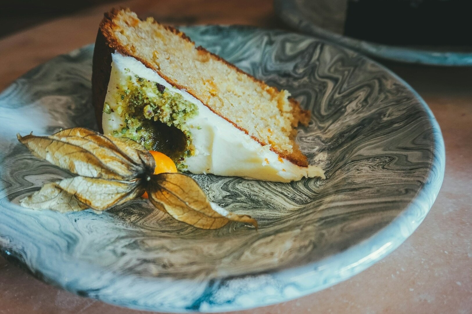 A piece of Toa Payoh’s Carrot Cake served on a plate, accompanied by a decorative flower.