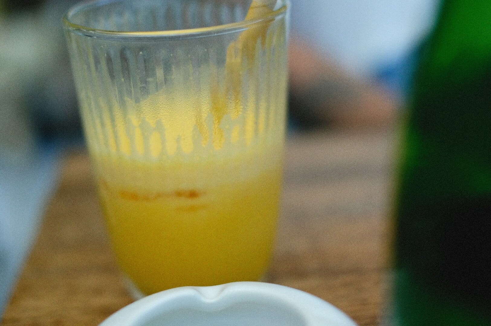 A clear glass filled with bright sugar cane juice, presented at Tiong Bahru Dessert, highlighting its freshness and appeal.