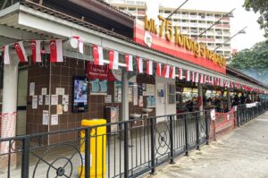 A black metal fence at Toa Payoh’s hawker centres, delineating the space and enhancing the area's structure.