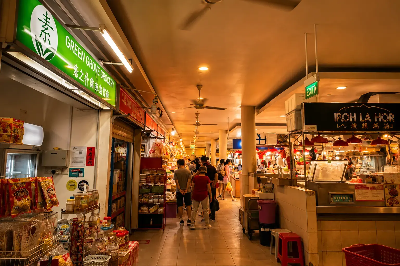An indoor market aisle lined with stalls, including "Green Grove Grocery" on the left and "Ipoh La Hor" on the right, with shoppers walking down the center under a warm glow.