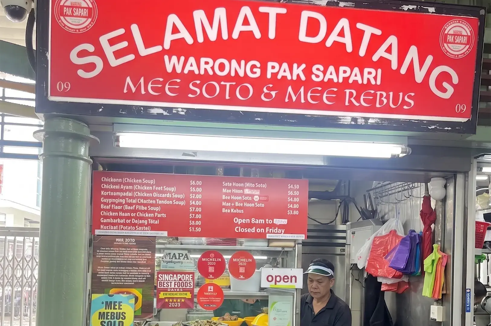 Warong Pak Sapari hawker stall storefront with a red sign advertising mee soto, mee rebus, and Michelin Guide awards.
